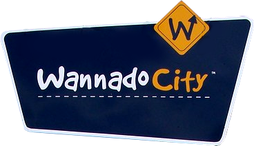 A logo in the shape of a highway sign. It reads Wannado City.
